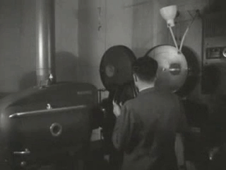 man loading a movie reel