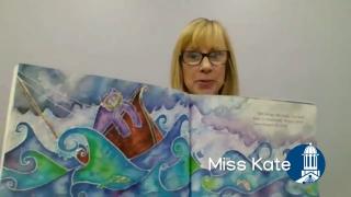 Miss Kate holding open a picture book